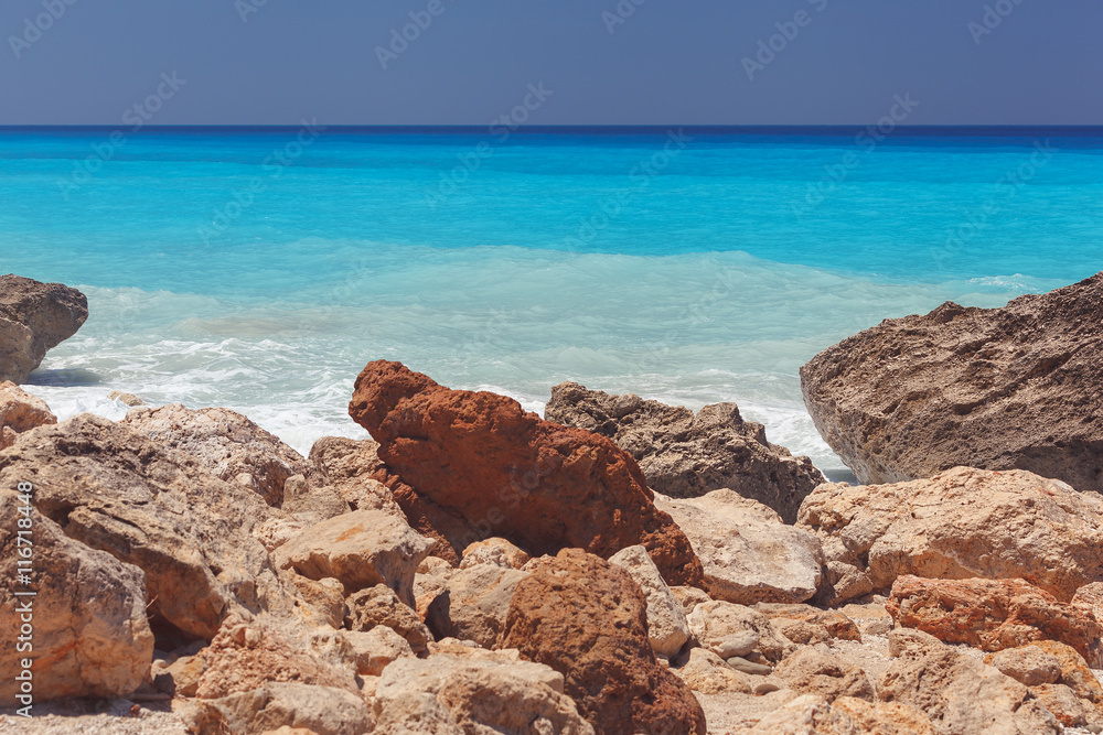 Beautiful rocky beach with clear turquoise water , close up. Island of Lefkada, Greece. Vintage toned image Beautiful rocky beach with clear turquoise water , close up. Island of Lefkada, Greece. Vintage toned image