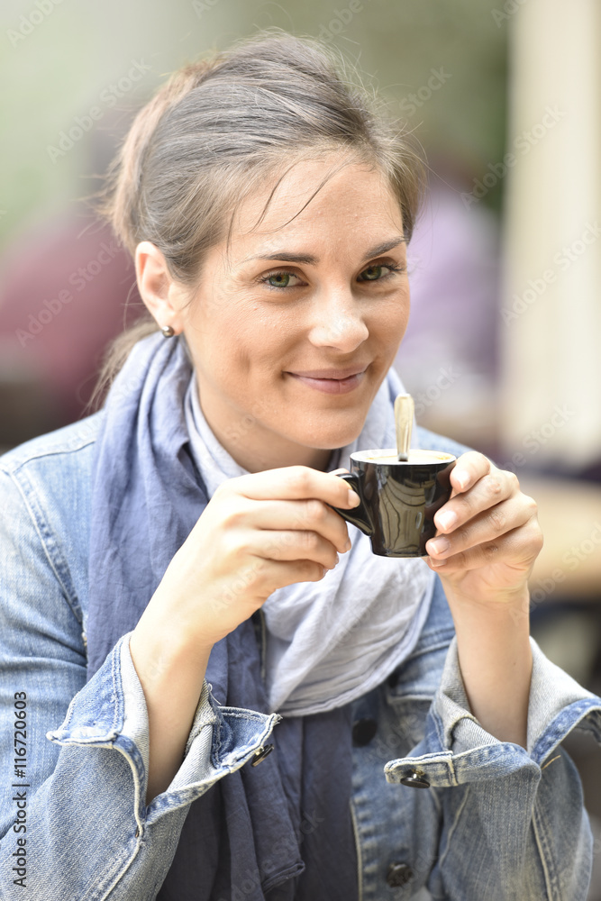 Portrait of young woman having coffee at cafŽ terrace Portrait of young woman having coffee at cafŽ terrace