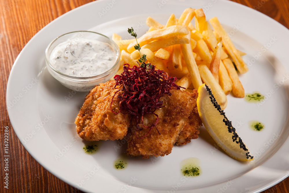 dish of meat in batter and fried potatoes dish of meat in batter and fried potatoes