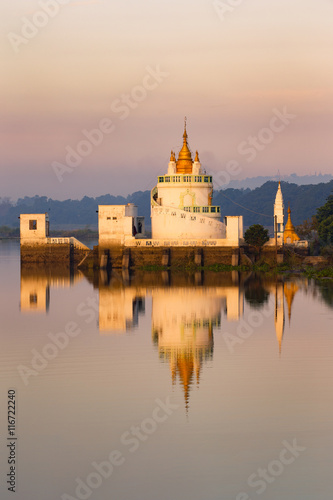 Reflection of building in lake against sky