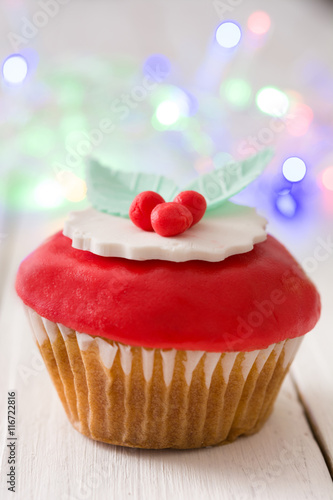 Christmas cupcakes and Christmas decoration
on white wood

