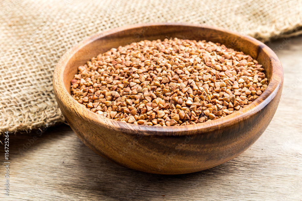 Bowl with Buckwheat on a wooden background Bowl with Buckwheat on a wooden background
