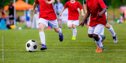 Fototapeta Naklejka Na Ścianę i Meble -  Boys playing soccer football match. International sport competition for youth soccer teams.