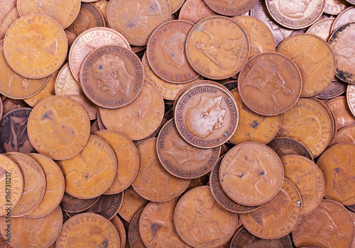 Old penny coins spread out for background