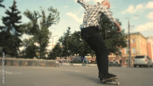 Young experience skateboarder flipping his skateboard underground photo