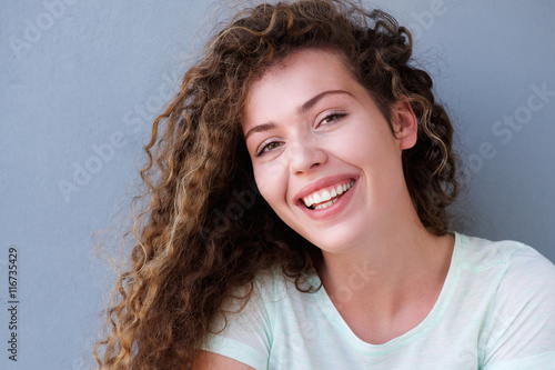 Smiling teen girl isolated on gray background