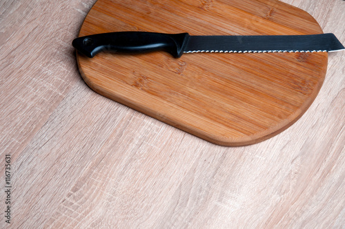 Wooden breadboard with knife