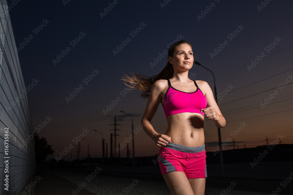 Fototapeta premium Running woman. Runner jogging in evening.