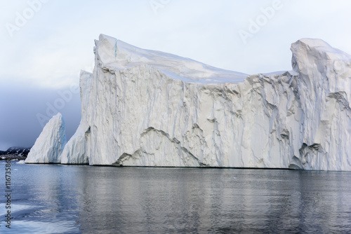 Icebergs are on the arctic ocean on sunset time with shadow