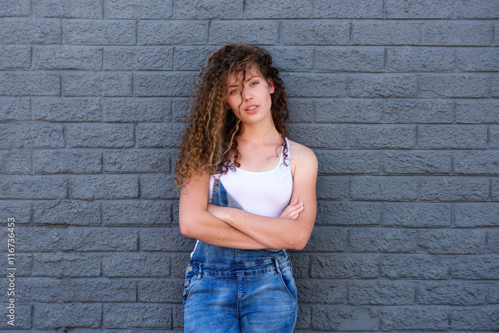 Serious girl standing with arms crossed and attitude Serious girl standing with arms crossed and attitude