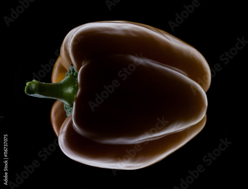 Yellow macro pepper isolated on black background
