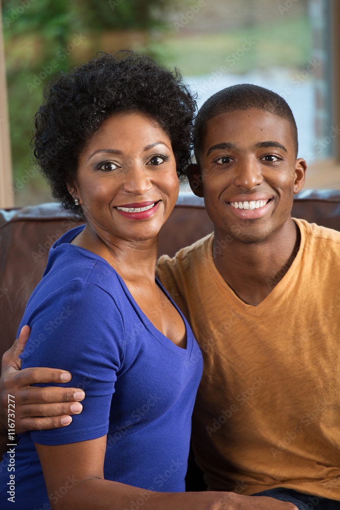 Woman Being Hugged By Her Adult Son Woman Being Hugged By Her Adult Son