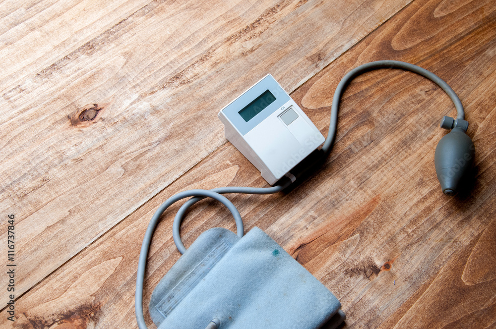 The image of pressure gauge on a wooden table The image of pressure gauge on a wooden table