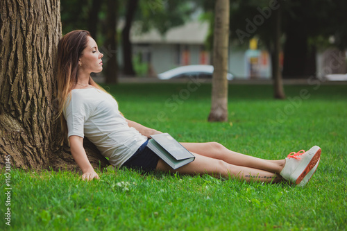 Girl with book under tree © UA_PM