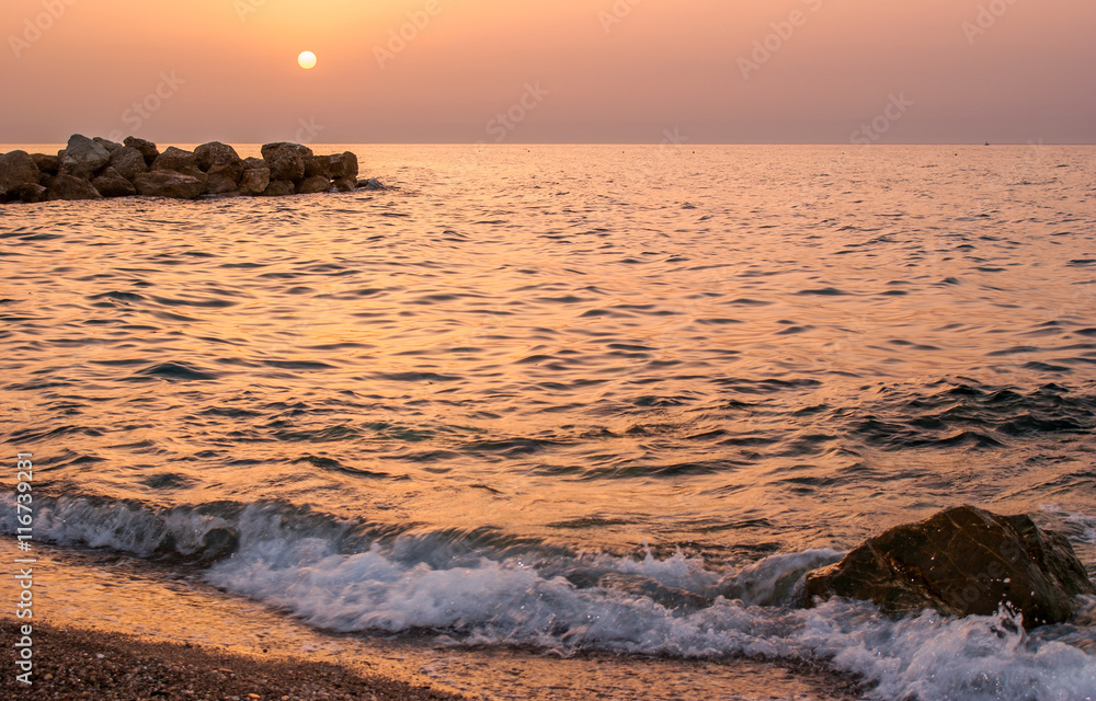 Naklejka premium Brolo beach at sunset. Sicily