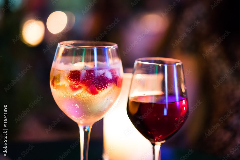 Fruity champagne cocktail/ Candlelit colourful drinks. Prosecco cocktail with seasonal fruits and red wine. Fruity champagne cocktail/ Candlelit colourful drinks. Prosecco cocktail with seasonal fruits and red wine.