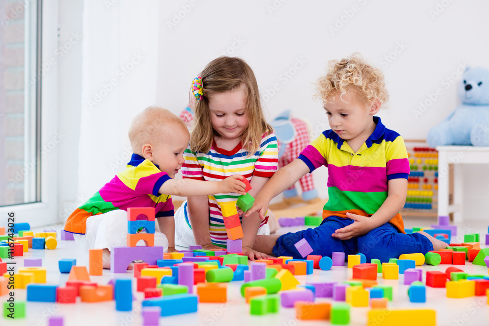 Kids playing with colorful toy blocks Kids playing with colorful toy blocks