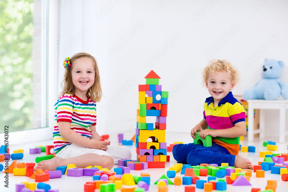 Fototapeta premium Kids playing with colorful toy blocks