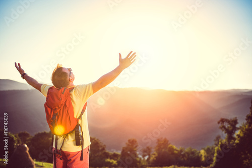 Man with arms outstretched on mountain