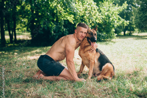 athletic guy with a German Shepherd © jul14ka