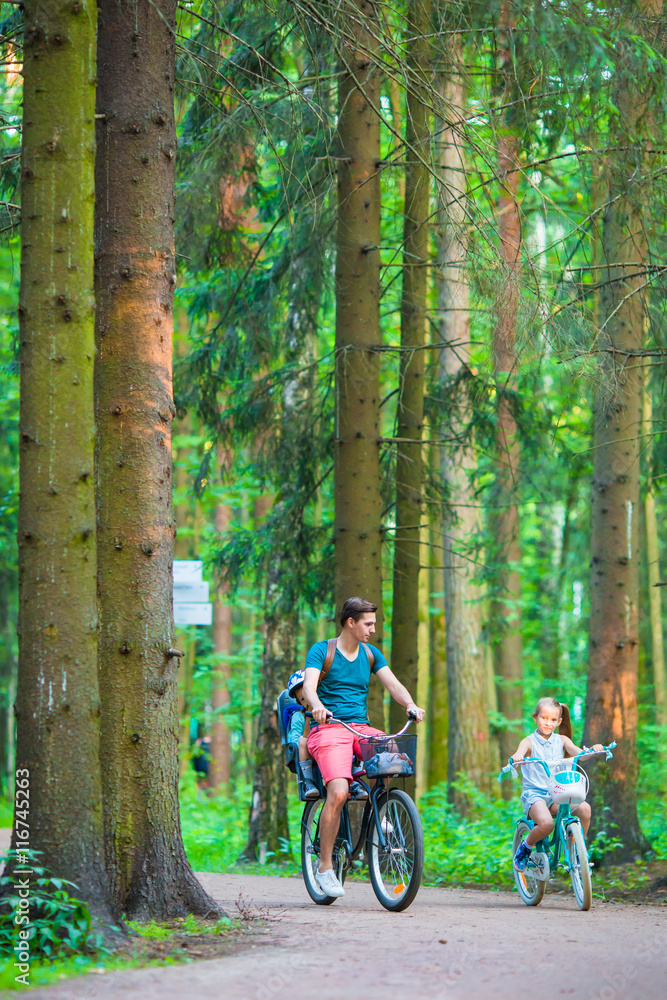 Happy family biking outdoors at the park