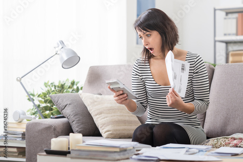 Woman checking expensive bills photo
