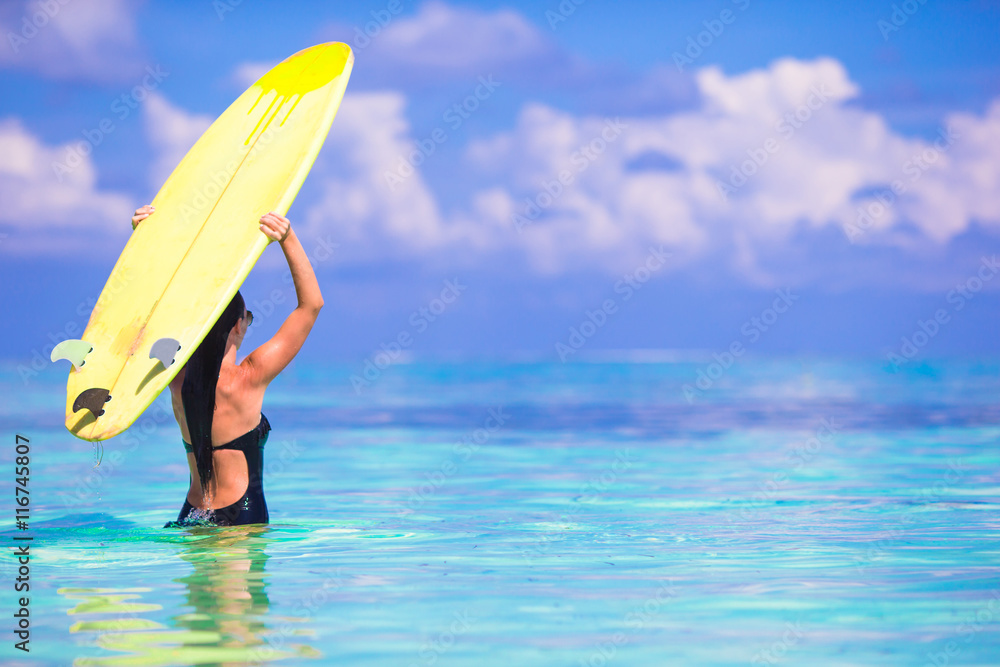 Beautiful surfer woman surfing during summer vacation