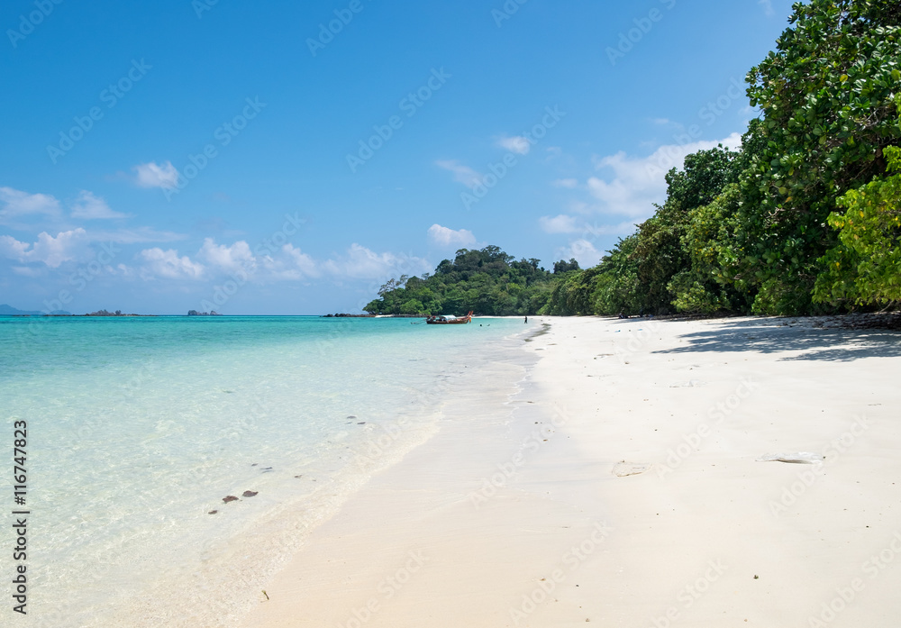 Long tail wooden boat anchor with csytal sea white sand at lipe island,andaman,thailand Long tail wooden boat anchor with csytal sea white sand at lipe island,andaman,thailand
