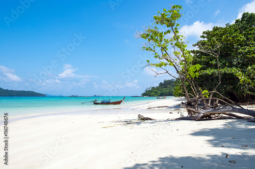 Long tail wooden boat anchor with csytal sea white sand at lipe island andaman thailand