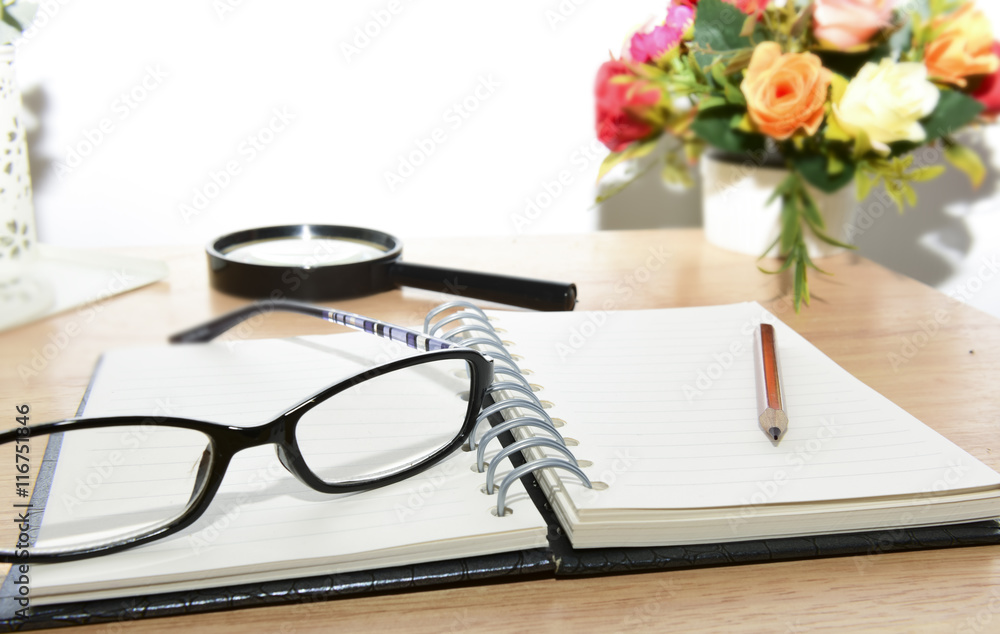 Open Blank notebook and pencil with magnifying glasses and Open Blank notebook and pencil with magnifying glasses and