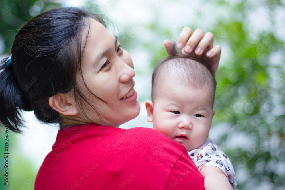 Mother and baby, Lovely asian girl resting on her mother's shoulder Mother and baby, Lovely asian girl resting on her mother's shoulder