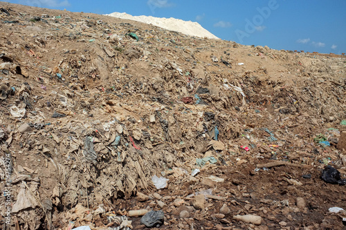 Garbage, household trash, plastic bags and toxic industrial waste next to contaminated water at a polluted landfill site in Bali, Indonesia.