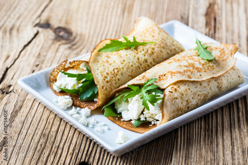 Crepes with arugula and cheese