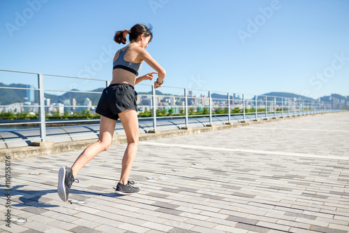 Asian Woman run in a city