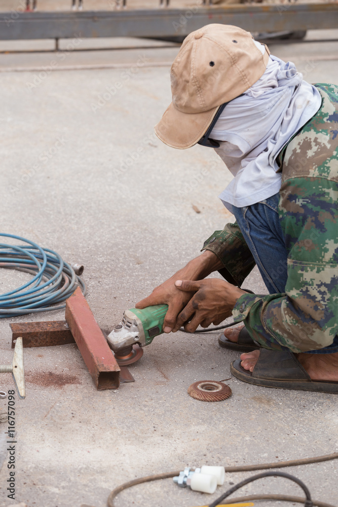 worker using grinder to grinding metal worker using grinder to grinding metal