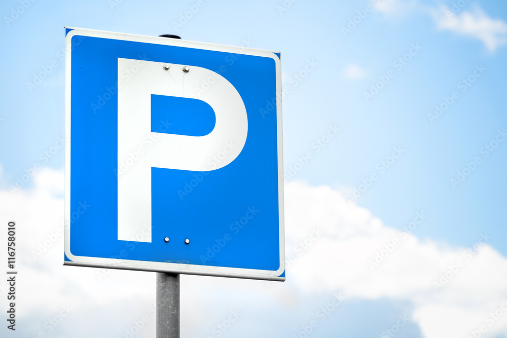 Blue square parking road sign over bright sky Blue square parking road sign over bright sky