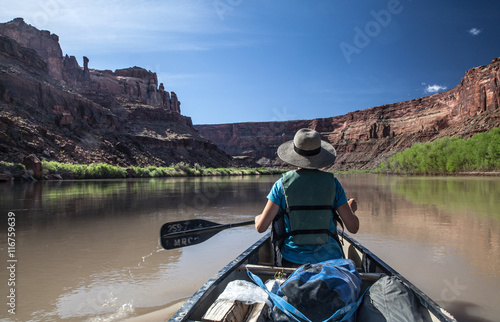 Woman paddling into the Labyrinth Canyon, Utah, USA