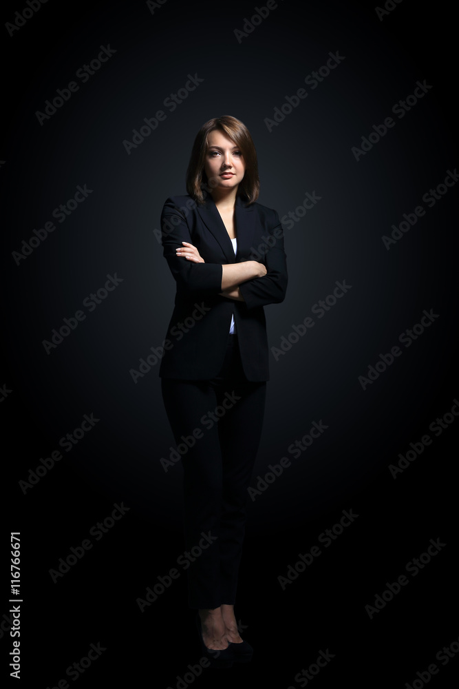 Full-length portrait of businesswoman isolated on black backgro Full-length portrait of businesswoman isolated on black backgro