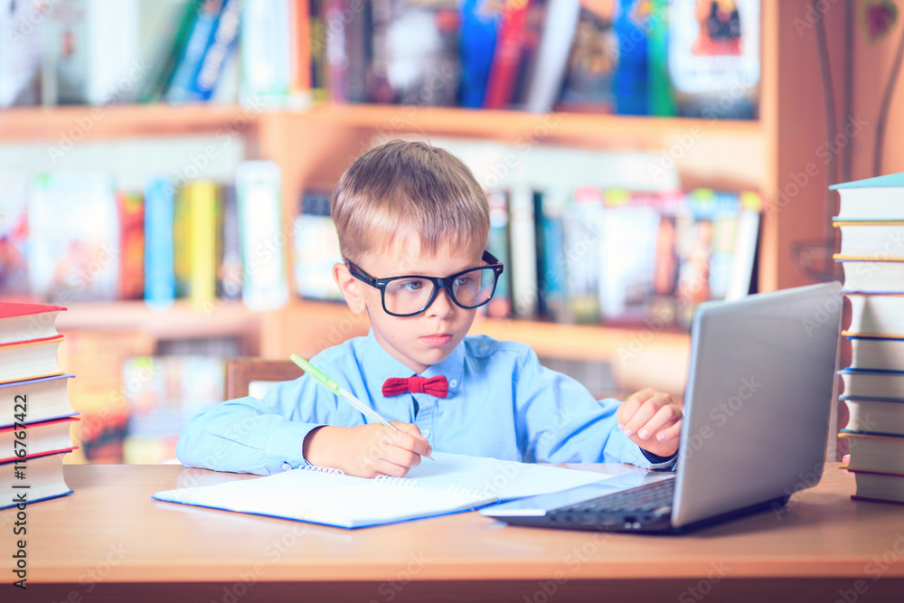 School Kid Studying in Library, Child Writing Paper Copy Book in School Kid Studying in Library, Child Writing Paper Copy Book in