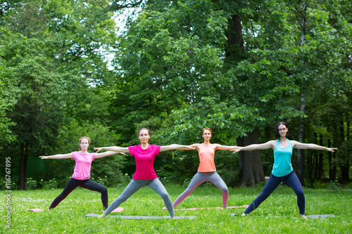 Group of beautiful young women doing yoga together. © BestForYou