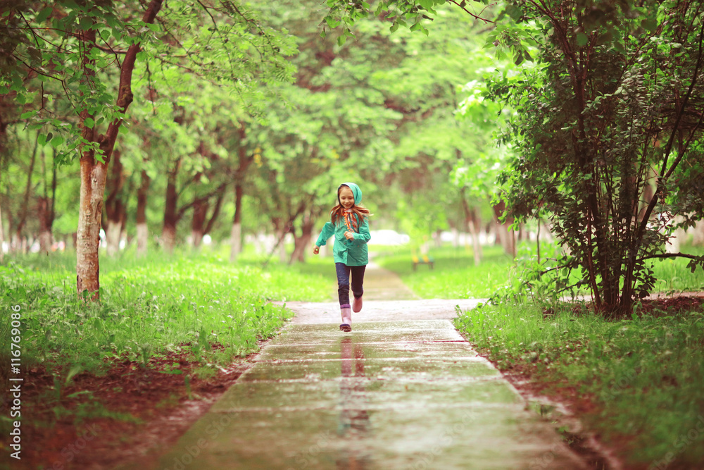 girl jumping in puddles spring rain girl jumping in puddles spring rain