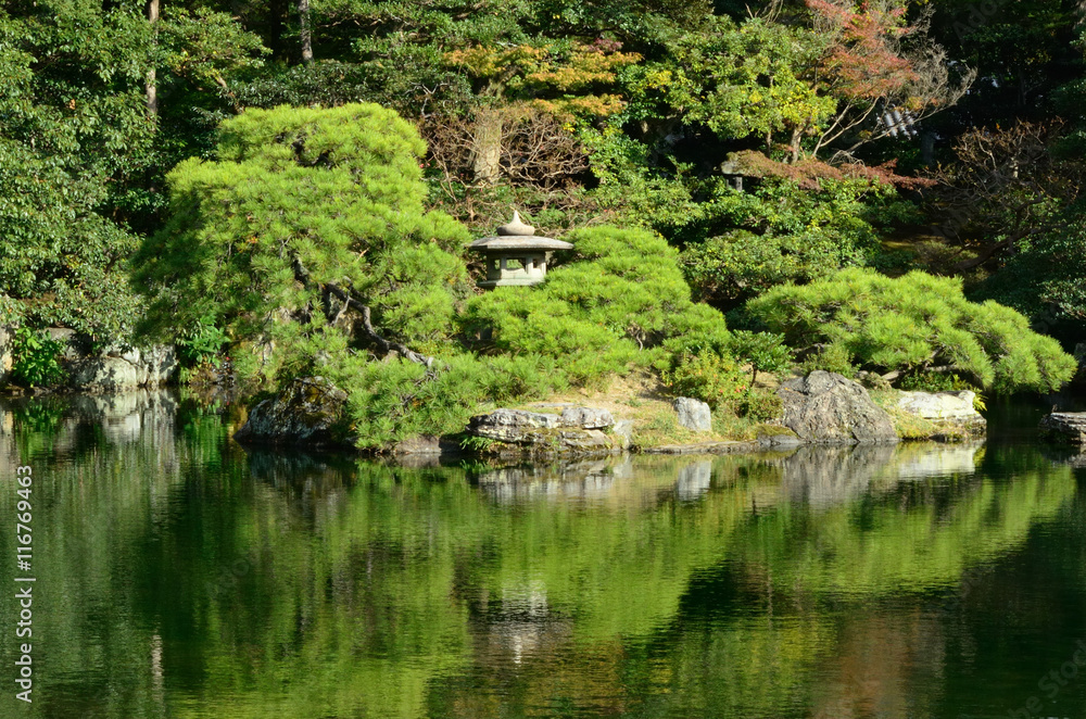Japanese garden, pond and stone lantern. Kyoto Japan.
