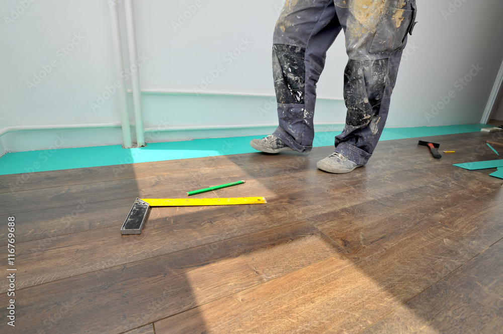 Carpenter doing laminate floor work Carpenter doing laminate floor work