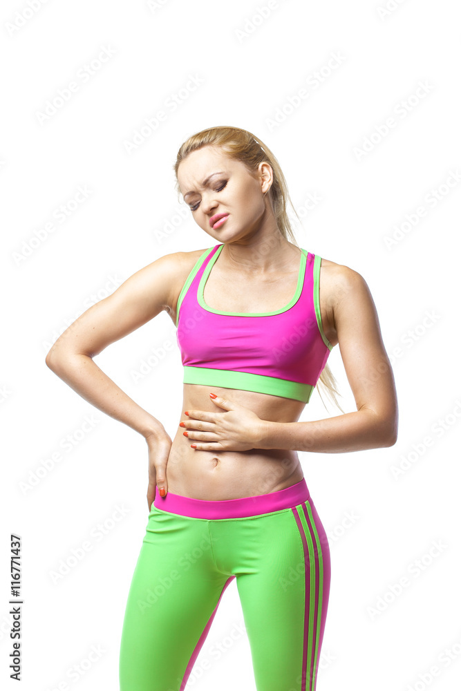 Fitness woman having pain in stomach over white Fitness woman having pain in stomach over white
