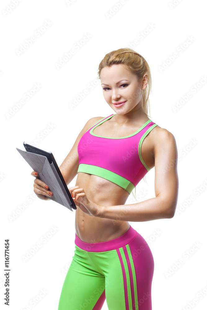 Beautiful young sportswoman using pc tablet and looking at camera Beautiful young sportswoman using pc tablet and looking at camera