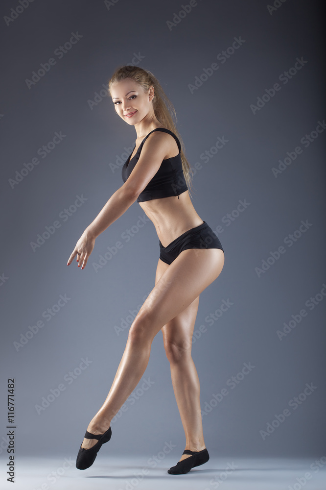 Young beautiful dancer posing on a studio background Young beautiful dancer posing on a studio background