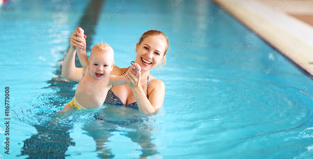 mother teaching baby swimming pool