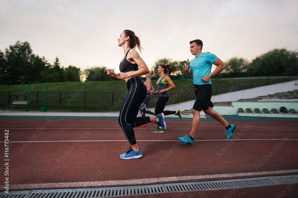 Obraz premium People running at the stadium. Group fitness training