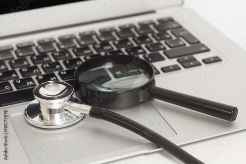 Laptop With Magnifying Glass And Stethoscope