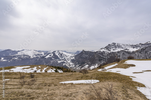 Monte Altissimo landscape with a field and some snow, Trentino, Italy